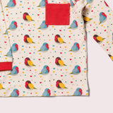 dettaglio maglietta fantasia di pappagalli e taschino rosso